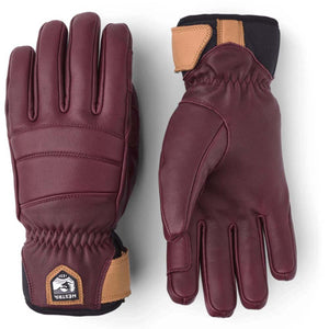 Hestra burgundy leather gloves with tan wrist strap and black cuff