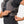 Person adjusting the side strap on a grey Nathan hydration vest
