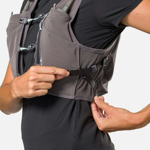Person adjusting the side strap on a grey Nathan hydration vest