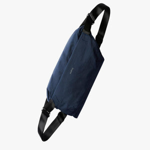 Navy blue Bellroy sling bag with black adjustable strap