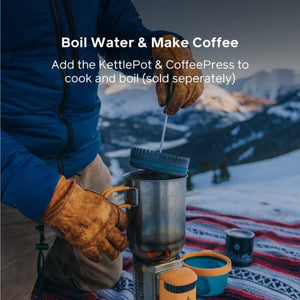 Person using a KettlePot and CoffeePress on a camping stove in a snowy mountain setting