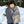Person wearing a black beanie and wrapped in a grey ActionHeat heated blanket outdoors in the snow