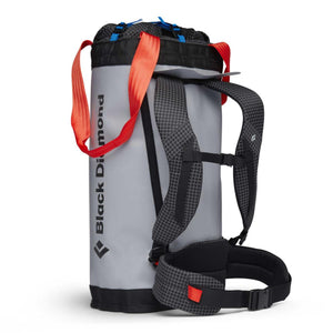 Black Diamond grey cylindrical haul bag with red shoulder straps and black grid pattern harness
