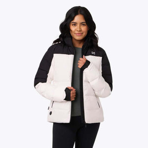 Woman wearing a white and black Mobile Warming heated puffer jacket