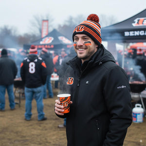 Man wearing ActionHeat jacket and Bengals beanie holding a branded paper cup at a tailgate