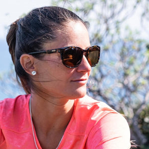 Person wearing Smith Optics tortoise shell sunglasses with brown lenses