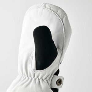 Hestra white leather mitten with black fabric insert and snap button closure