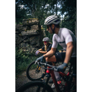 Two cyclists wearing Hestra gloves on a forest trail