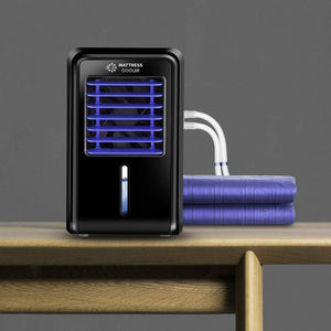 Mattress Cooler unit with blue cooling pad and connecting tubes on a wooden table