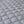 Close up of grey quilted fabric with diamond pattern