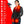 Woman wearing ActionHeat heated scarf with feature list including neck heating, pockets, and power bank details