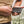 Person connecting a Gobi Heat battery pack to a heated vest