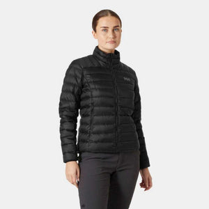Woman wearing a black Helly Hansen quilted down jacket with a high collar and HH logo