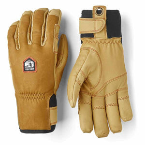 Hestra tan leather gloves with black cuffs and wrist adjustment straps