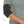 Person wearing a black electric elbow brace with a power cord