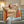 Woman sitting on a couch using a UTK Technology infrared heating pad
