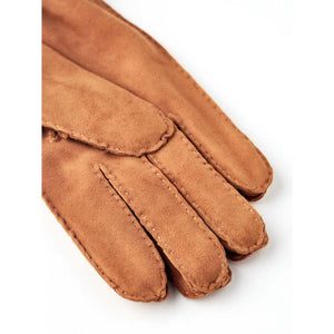Hestra tan suede gloves with visible stitching