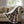 Woolrich brown plaid heated throw blanket with white sherpa lining draped over a beige sofa