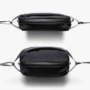Top and side view of a black Bellroy sling bag with a zippered closure