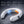 White wearable neck fan with blue and orange cooling panels and digital battery display