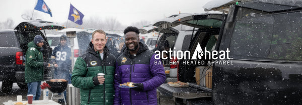 Two smiling men, one in a green Packers jacket and one in a purple Vikings jacket, hold food and drink while tailgating in the snow. A logo 