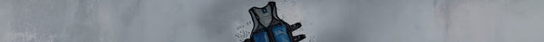 A black mesh cooling vest with blue panels lies on a grey surface, surrounded by scattered clear ice cubes.