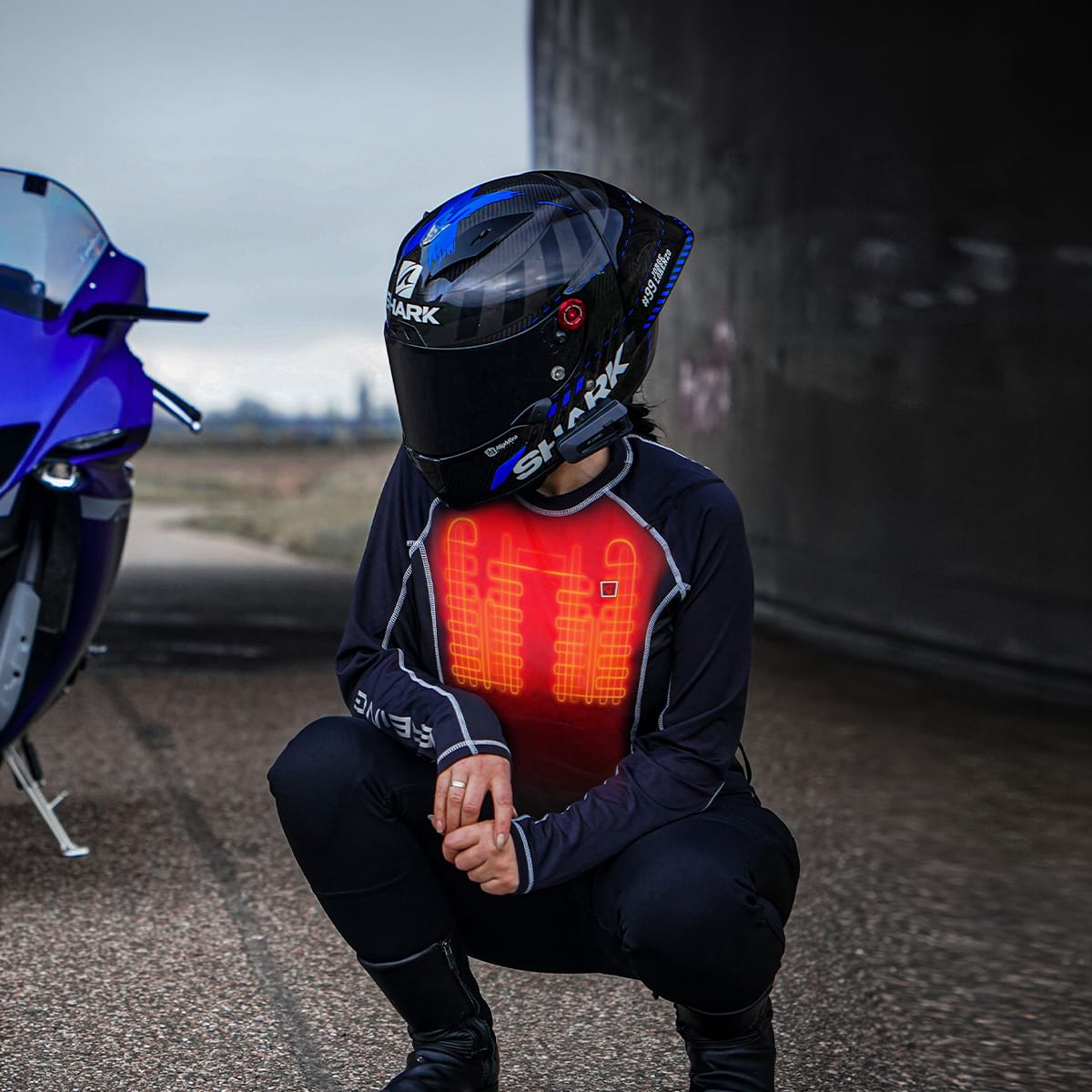 Motorcyclist wearing a Shark helmet and a heated base layer with visible red heating elements