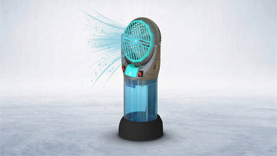 A grey and teal portable evaporative cooler with a clear water tank and black base, emitting a blue cooling mist from its fan, on a light grey background.