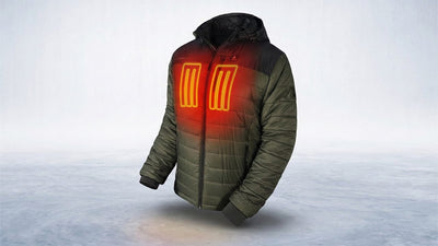 An olive green ActionHeat puffer jacket with black shoulders and hood, displaying glowing orange heating elements on the chest, floats above a cold, icy landscape.