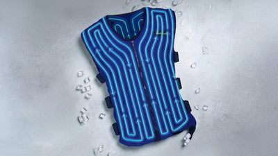 A blue cooling vest with glowing internal blue lines and arrows lies on a light grey surface with scattered ice cubes. A 