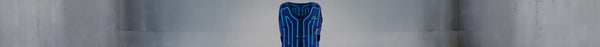 A blue vest with glowing light blue lines and arrows indicating flow, centered against a blurred grey concrete background.