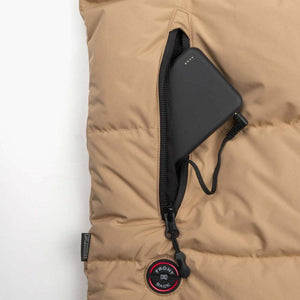Mobile Warming tan vest pocket with black power bank and charging cable connected