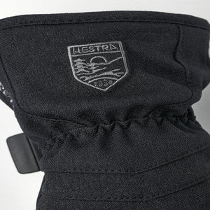 Black Hestra glove cuff with embroidered brand logo patch
