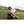 Woman sitting on grass using an ExtremeMIST cooling spray bottle