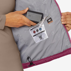 Person inserting a Venture Heat battery into the interior pocket of a heated jacket