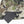 Mobile Warming battery pack connected to a zippered pocket on camouflage fabric