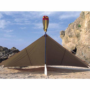 Snow Peak tarp set up on a sandy beach with a paddle as a support pole