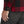 FjallRaven red and black plaid shirt cuff detail with button and black trousers