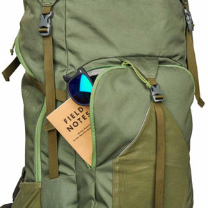 Kelty backpack front pocket containing a Field Notes notebook and sunglasses