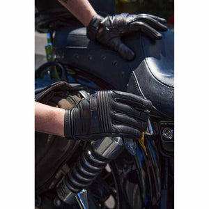 Milwaukee Leather black motorcycle gloves worn by a rider on a motorcycle