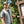 Man wearing a Chill-Its cooling vest standing next to a park trail map