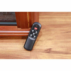 Black remote control for electric fireplace with power flame timer and heater buttons on wooden floor