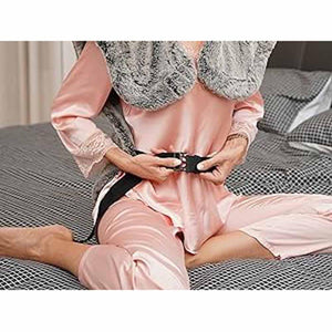Person wearing a UTK Technology heating pad with a black strap around their waist