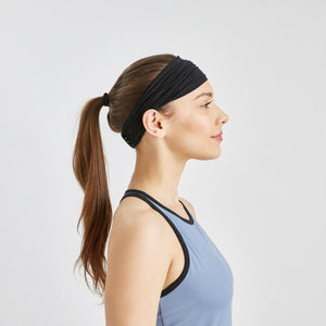 Side profile of a person wearing a black Mission athletic headband