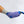 Foot wearing a grey sock with a blue ice pack secured by a purple elastic compression wrap
