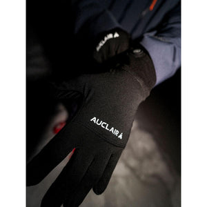 Person wearing black Auclair gloves with white logo