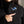 Person pressing the power button on a black ActionHeat Detroit Lions heated vest