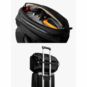Bellroy backpack showing interior organization and luggage pass-through strap attached to suitcase handle