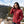 Woman wearing a red Gobi Heat jacket on a snowy mountain trail