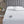 White electric heated mattress pad with dual controllers on a bed with a grey tufted headboard
